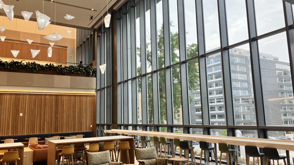 McCourt Building Open Space, with vast window, seats, and origami light fixtures