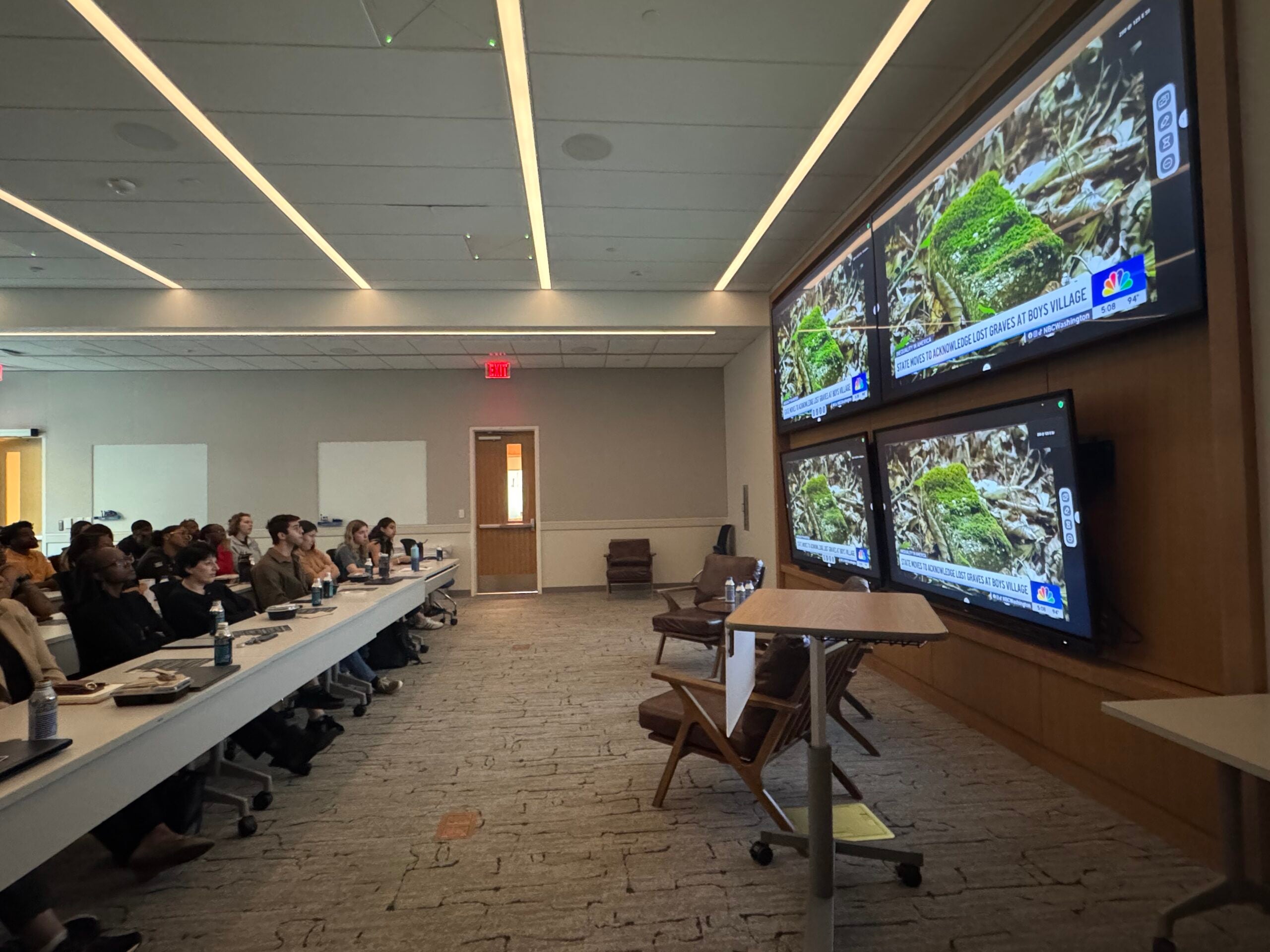Room with multiple monitors playing "Lost Shoes" short video at the Youth Injustice Lunch.