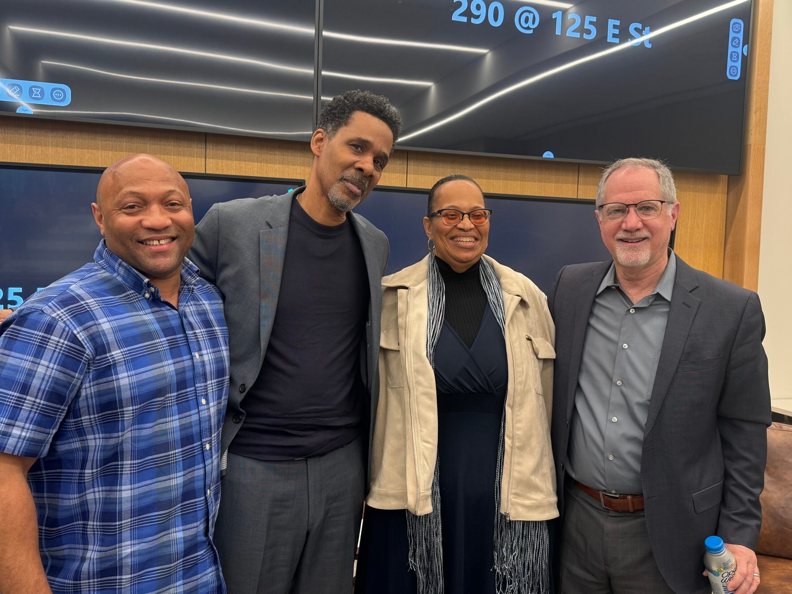 Tyrone Walker, Clint Lacey, Chaplain Gwen Bankins, and Marc Schindler smiling in a row