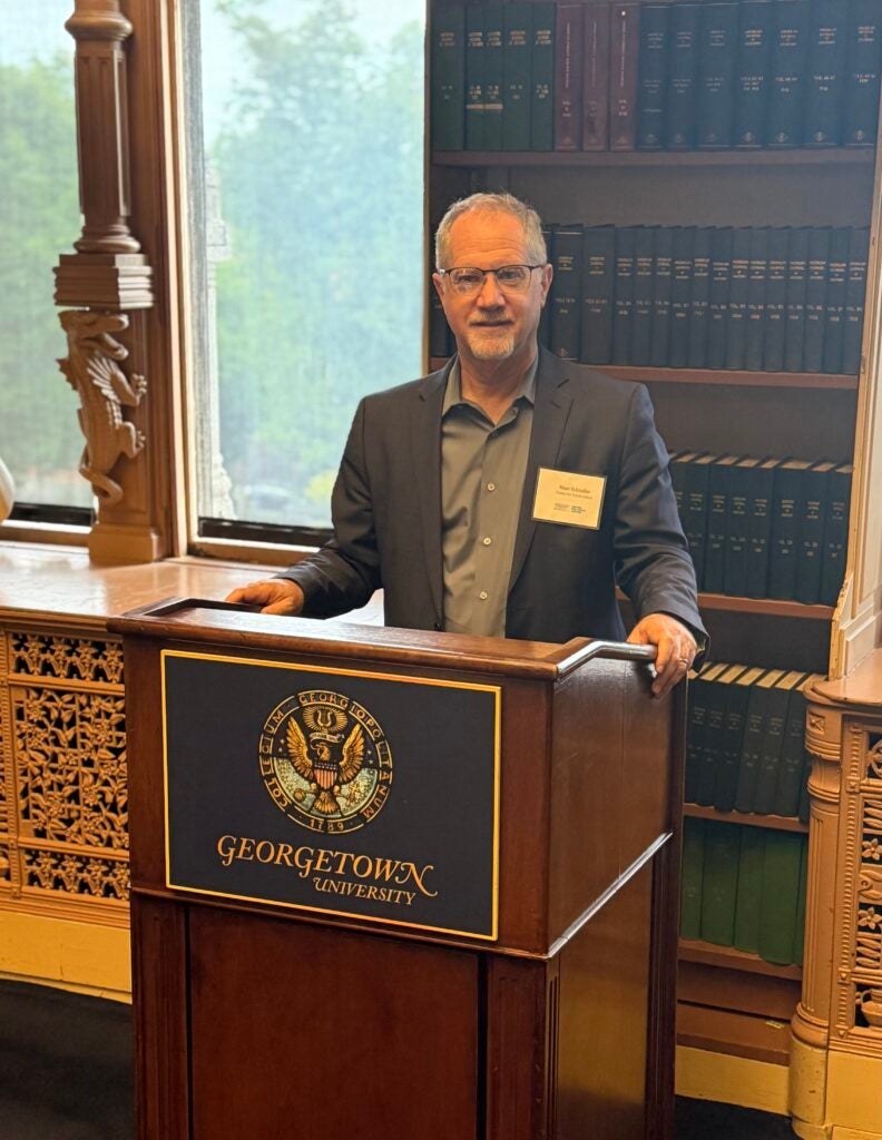 Marc Schindler speaking from a Georgetown podium