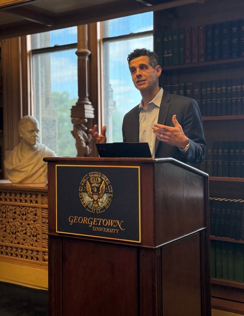 Nate Balis speaking from a Georgetown podium