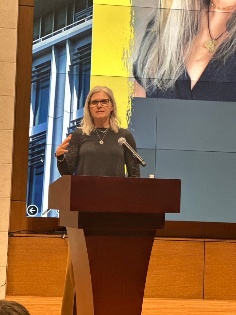 Dr. Herz speaking at podium