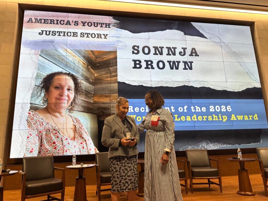 Sonnja Brown and Macon Stewart smiling on stage