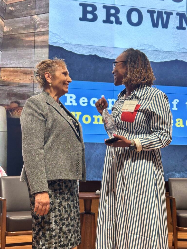 Sonnja Brown and Macon Stewart smiling on stage
